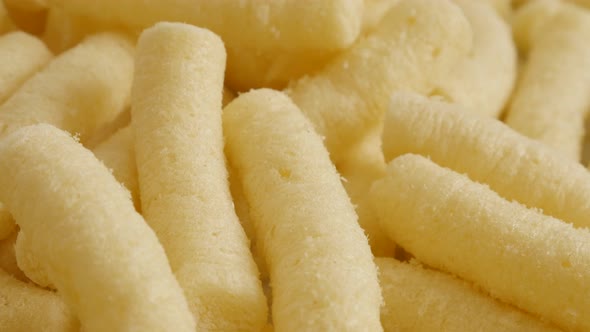 Close-up of puffcorn snack in the bowl  slow tilt 4K 2160p 30fps UltraHD footage - Popular corn flip alt