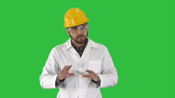 Confident Engineer Man Talking Camera on a Green Screen alt
