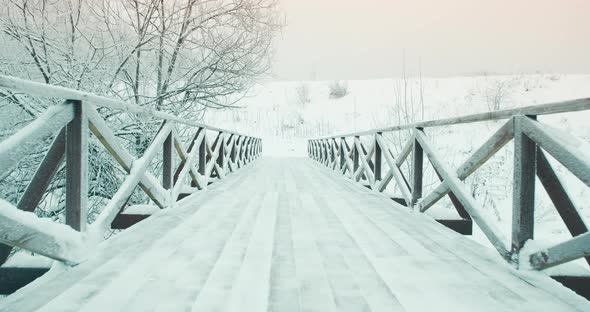 Winter Wooden Pedestrian Bridge in Park in Nature