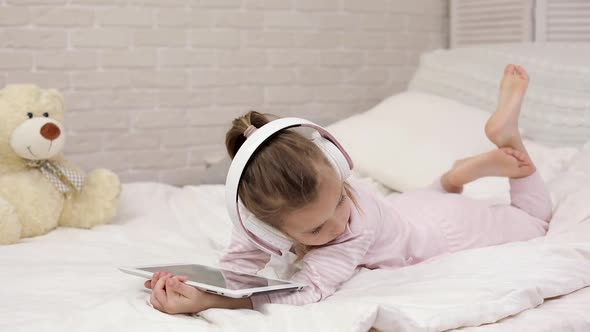 Little Child Baby Girl Listening To the Music with Headphones
