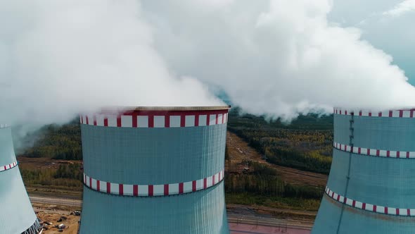 Flying Over the Smokefilled Cooling Tower of a Nuclear Power Plant