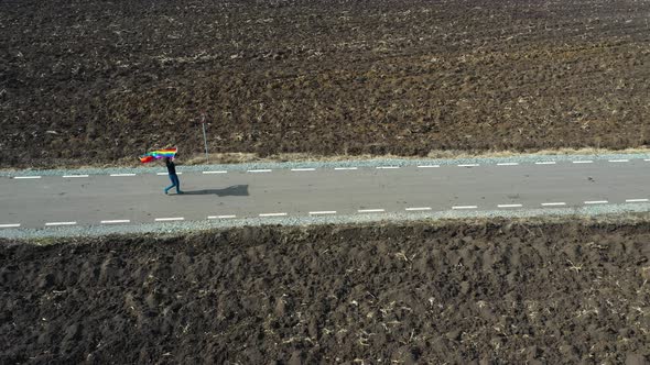 Woman with gay flag - drone view