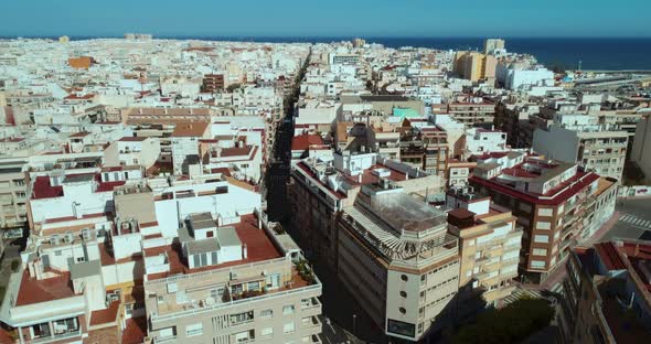 Drone Flying Above Roofs in Tourist Mediterranean City at Sunny Summer Day alt