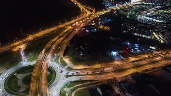 Aerial Drone Time Lapse Car Traffic Jam Roundabout Circle Interchange Road at Night Top View alt
