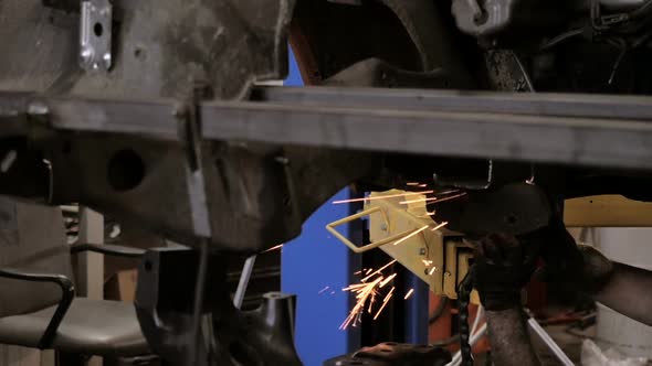 Workman Cuts Iron Details Via Plasma Cutter