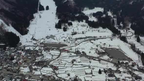 base of the mountain ski resort in nozawa onsen nagano japan with little snow in winter, aerial alt
