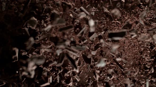 Super Slow Motion Shot of Raw Chocolate Chunks and Cocoa Powder after Being Exploded alt