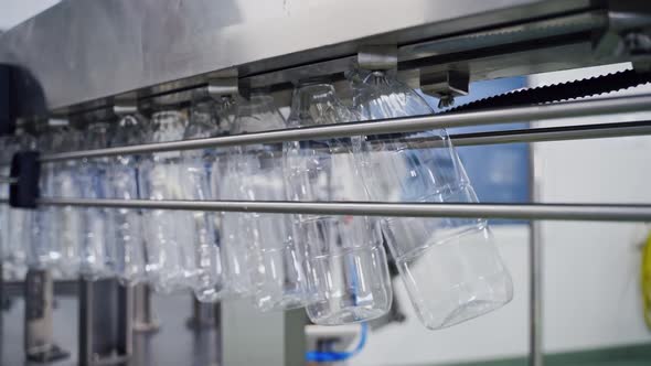 Empty plastic bottles on conveyor line. alt