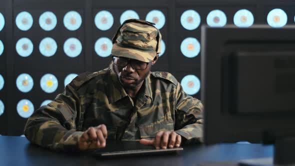 Africanamerican Man Dressed in Military Uniform Types on Keyboard of PC