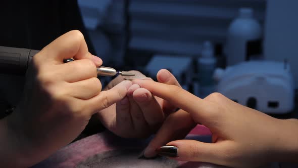 Anonymous Beautician Doing Manicure to Female Client