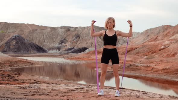 Woman working out on lifeless dried locality