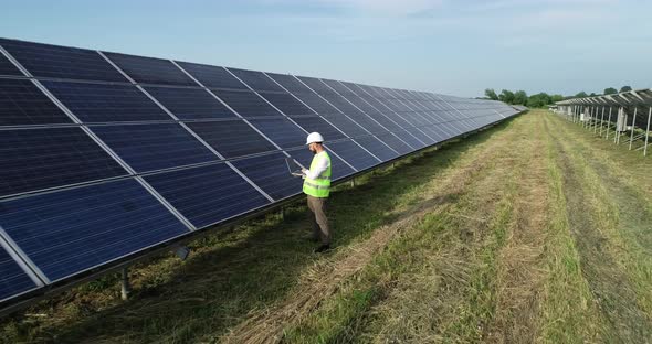 Solar Power Engineer Working on a Solar Farm alt