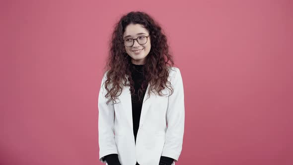 The Sincere Smile of a Mature Young Woman with Curly Hair alt