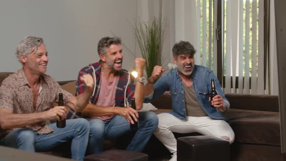 Cheerful friends watching TV while resting in room alt