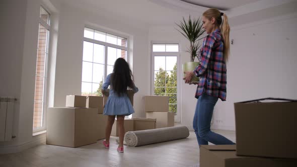 Happy Family Carrying Boxes Moving in New House alt