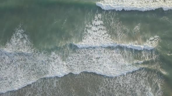  Aerial top down view of foaming breaking waves in sea, ocean. Water surface, scenic seascape summer