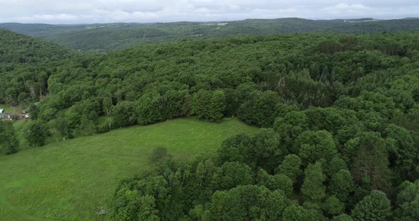 A drone floats backward revealing a beautiful Catskill Mountain landscape in upstate New York near W alt
