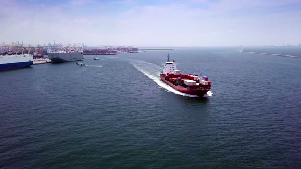 Aerial view of logistics concept cargo ship sailing out to the open sea leaving Laem Chabang dockyar alt