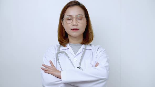 Portrait Smart Doctor, Asian female doctor standing with her arms crossed and smiling confidently