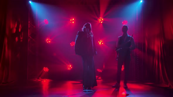 Silhouette a Beautiful Girl Vocalist Singing and Gestures with His Hands on Stage in a Vintage alt