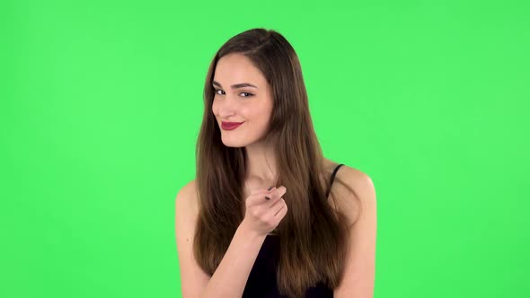 Girl Listens Carefully, Threatens with a Finger and Waves Her Head Seductively. Green Screen alt