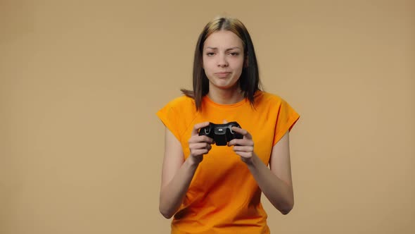Portrait of Fashion Model Playing Video Game Using Wireless Controller and Rejoicing in Victory alt