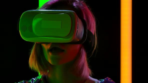 Portrait of a Young Stylish Woman with Virtual Reality Goggles. Close Up. Slow Motion. alt