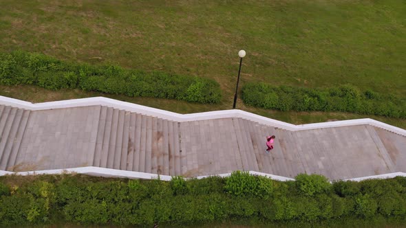 Teen Girl Runs Up the Stairs. Sport. Aerial Shooting