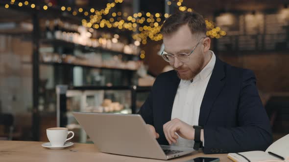 Man Working at Cafe and Typing alt