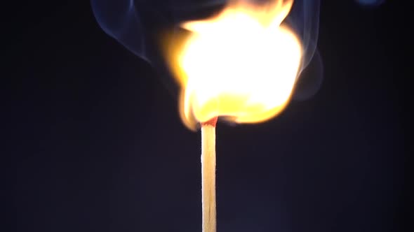 Striking Match and Burning on Black Background. Slow Motion alt