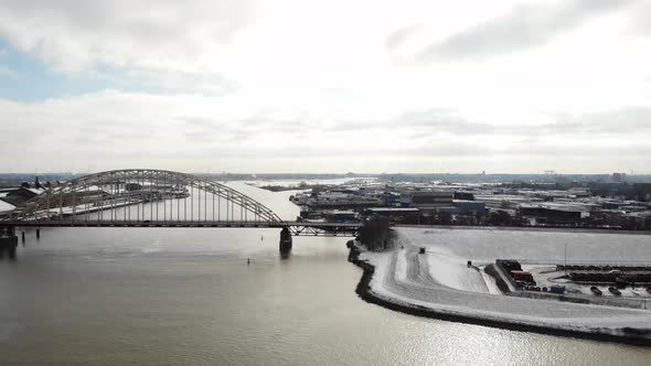 Aerial view of road bridge over river in an urban area in the Netherlands alt
