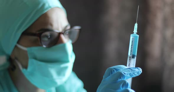 Doctor holding a syringe with the coronavirus COVID-19 vaccine