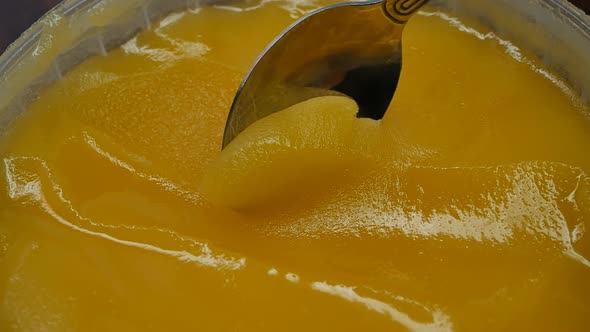 a Metal Spoon Takes Honey with a Thick and Yellow Color