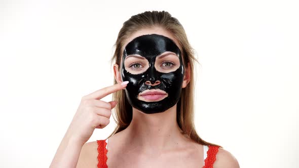 Girl with Dried Peel-off Black Mask on Face