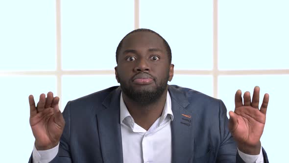 Funny Afro-american Businessman Making Grimace. alt