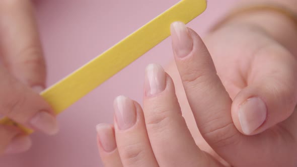 Closeup Woman Hand on Pink Makes Manicure for Herself