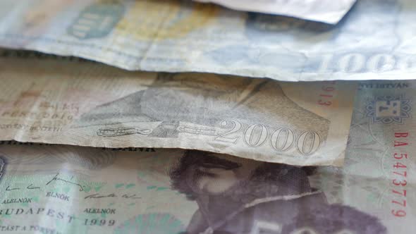 Hungarian forints paper banknotes on the row slow tilt 4K 2160p 30fps UltraHD video - Tilting over p alt