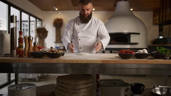 Baker Man Kneading Dough in Kitchen alt