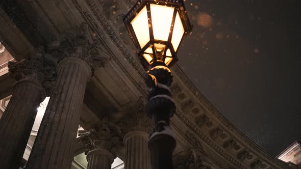 Streetlight Near Building with Columns in Winter Evening alt
