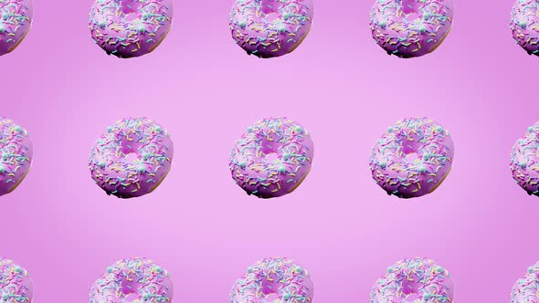 many fresh donuts rotating close-up above a pink bright background
