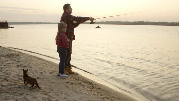 Father Teaching Daughter To Catch Fish in Morning