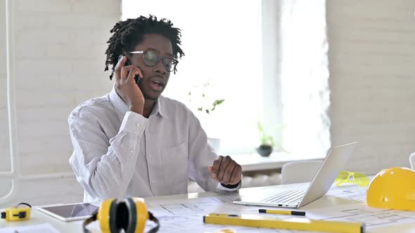 African Engineer Talking on Phone alt