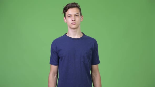 Young Handsome Teenage Boy with Arms Crossed alt