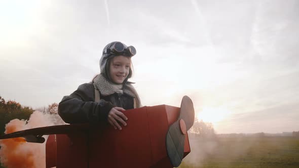 Little Girl Running in Sunset Field in Plane Costume alt