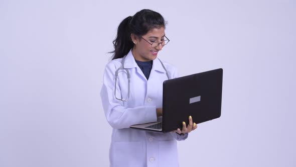 Young Happy Persian Woman Doctor Using Laptop alt