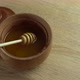 Honey with Wooden Honey Dipper in Wooden Bowl on Wooden Table - VideoHive Item for Sale