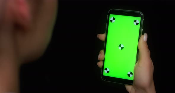 Woman Using Mobile App on Green Screen Phone Pokes at the Center of the Screen