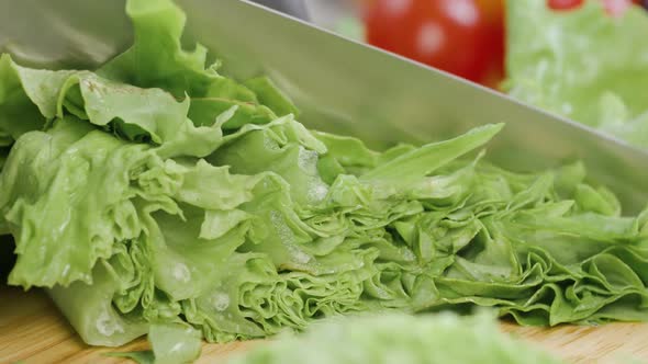 Chef Cuts the Salad Leaves with a Knife in Slow Motion Making a Salad Fresh Vegetables on a Cutting alt