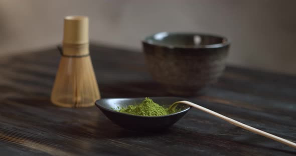 Matcha Organic Green Tea. Matcha Tea Ceremony. Matcha Powder. Rotation 360 on Black Wood Table.