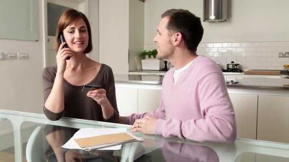 Couple on telephone with credit card alt